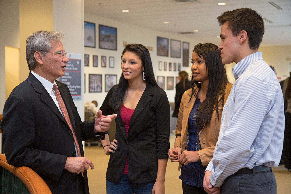 Students talking with faculty member in Gaughan Center