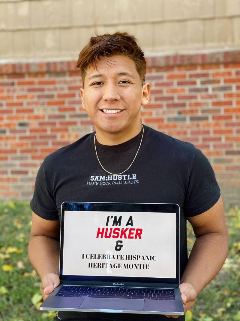 Francisco holding a sign that says "I'm a Husker and I celebrate Hispanic Heritage Month."