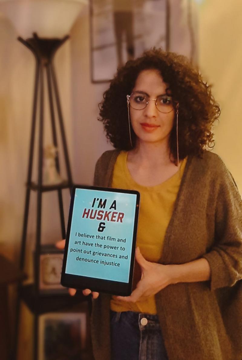 Vianne holds and iPad that says “I’m a Husker & I believe that film and art have the power to point out grievances and denounce injustice”